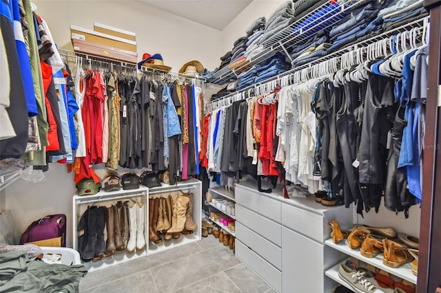 walk in closet with light tile patterned floors