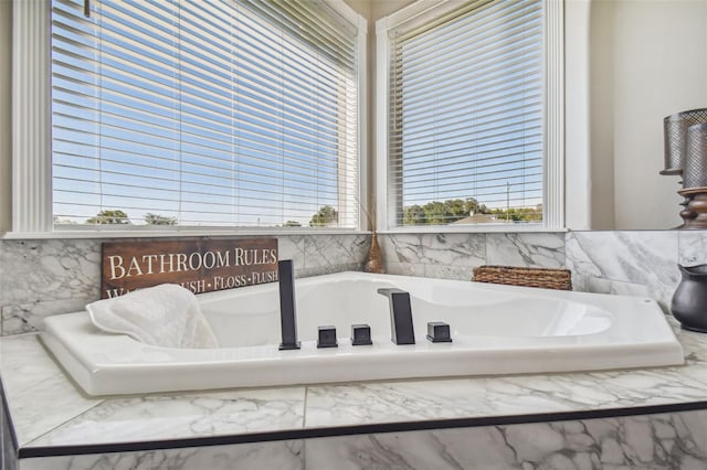 bathroom with a tub to relax in