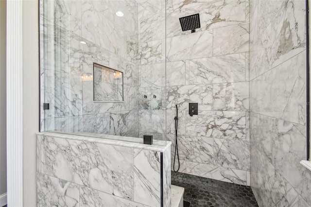 bathroom with a tile shower