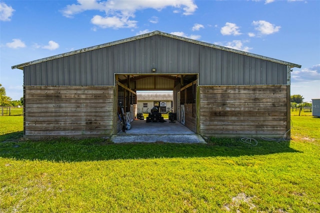 garage featuring a yard and wooden walls