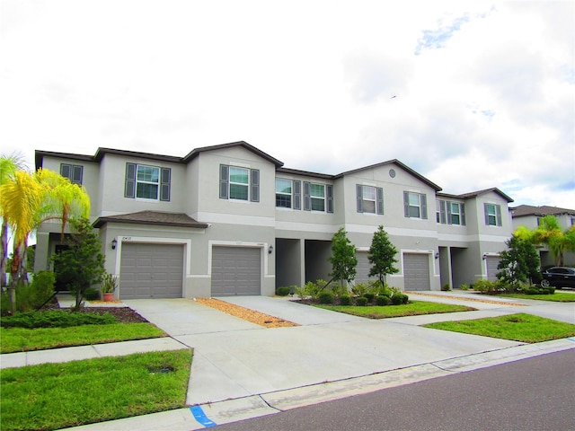 townhome / multi-family property featuring a garage