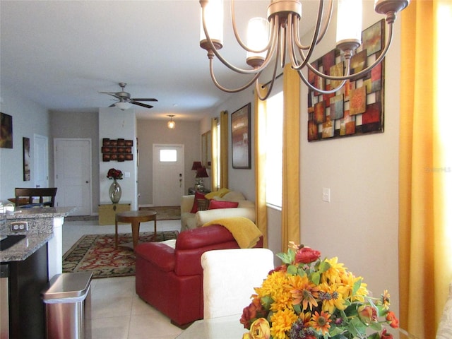 living room with ceiling fan with notable chandelier