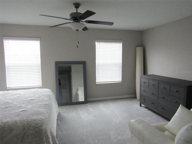 bedroom featuring ceiling fan and light carpet