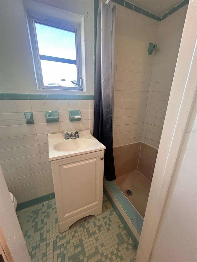 bathroom featuring tile walls, curtained shower, vanity, tile patterned flooring, and toilet