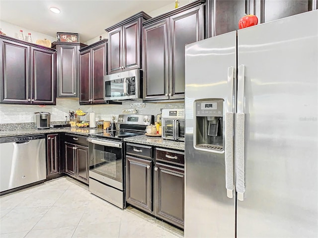 kitchen with recessed lighting, appliances with stainless steel finishes, stone countertops, light tile patterned flooring, and dark brown cabinets