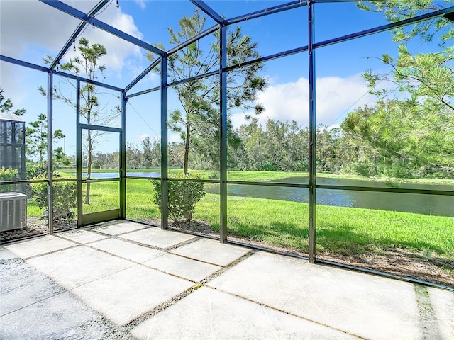 unfurnished sunroom featuring a water view