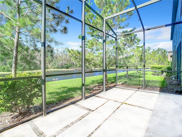 unfurnished sunroom featuring a water view