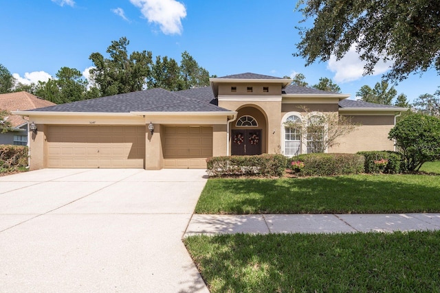 view of front of property featuring a front yard and a garage