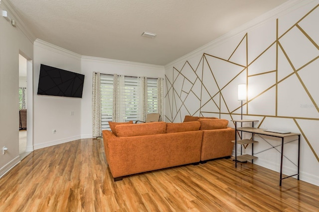 living room featuring ornamental molding, a textured ceiling, and wood-type flooring