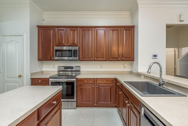 kitchen with ornamental molding, sink, appliances with stainless steel finishes, and light tile patterned flooring