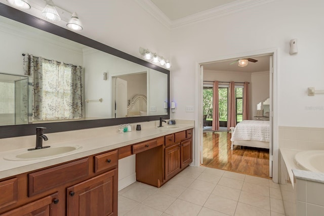 bathroom with vanity, crown molding, a tub to relax in, and tile patterned flooring