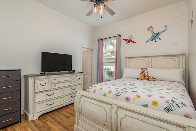 bedroom with ceiling fan, crown molding, and wood-type flooring