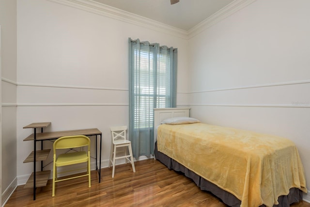 bedroom featuring crown molding, wood-type flooring, and ceiling fan