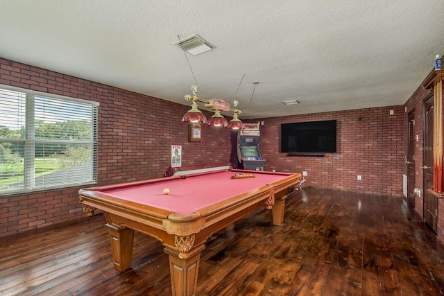 playroom featuring brick wall, dark hardwood / wood-style floors, and billiards