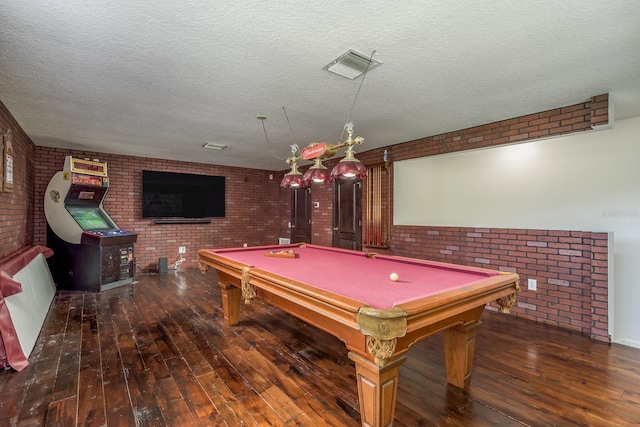 recreation room featuring brick wall, billiards, and dark hardwood / wood-style floors