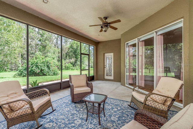 sunroom / solarium featuring ceiling fan