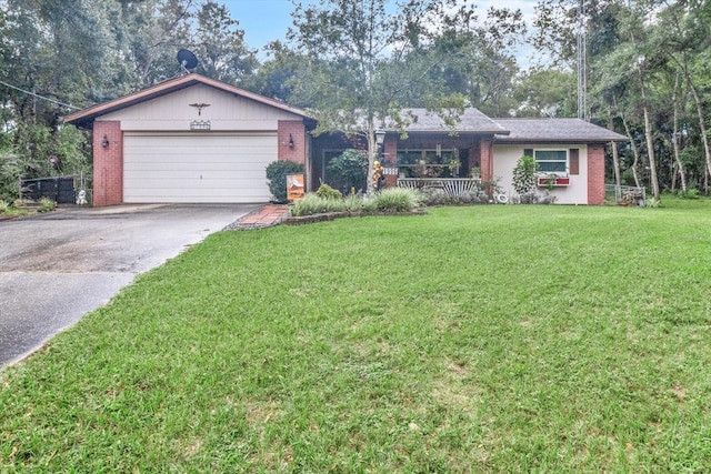 single story home with a porch, a garage, and a front lawn