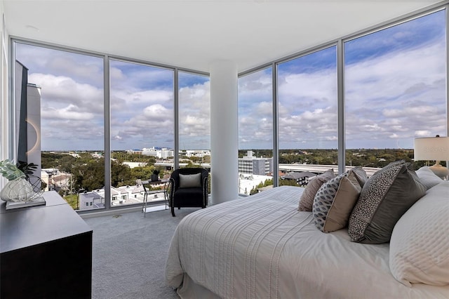 bedroom featuring carpet flooring, floor to ceiling windows, and multiple windows