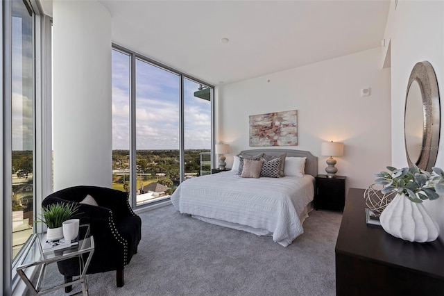 bedroom featuring carpet floors and a wall of windows