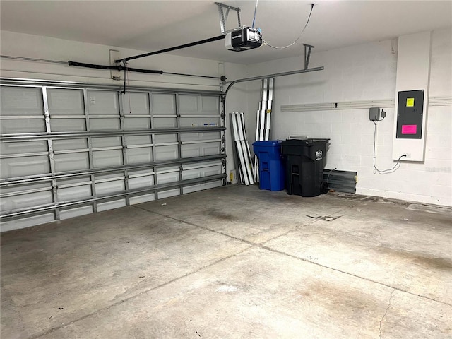 garage with electric panel and a garage door opener