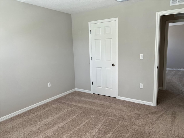 unfurnished bedroom featuring a textured ceiling and carpet flooring