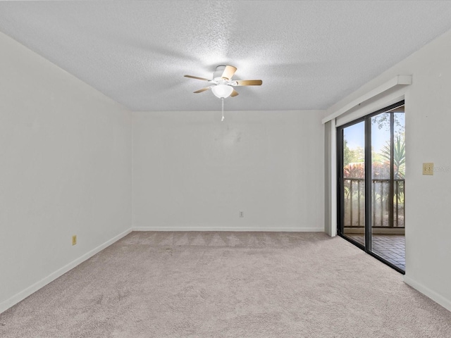 carpeted spare room with a textured ceiling and ceiling fan