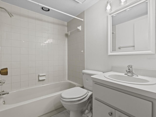 full bathroom with tiled shower / bath, vanity, and toilet