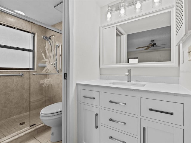 bathroom featuring ceiling fan, vanity, tile patterned floors, walk in shower, and toilet