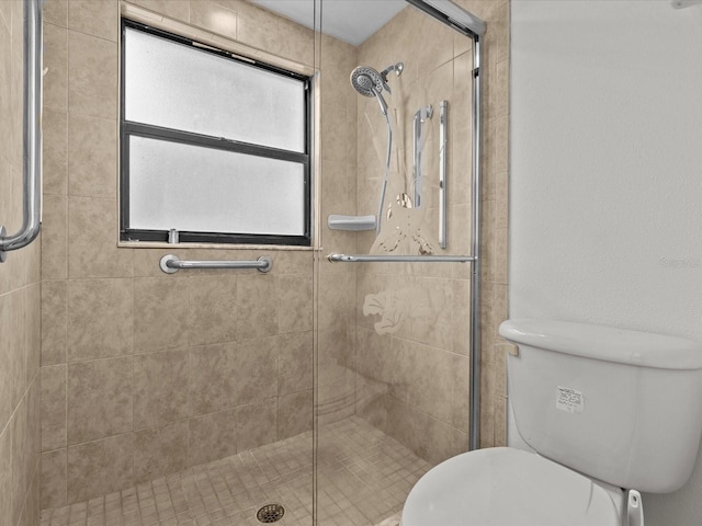 bathroom featuring toilet and an enclosed shower