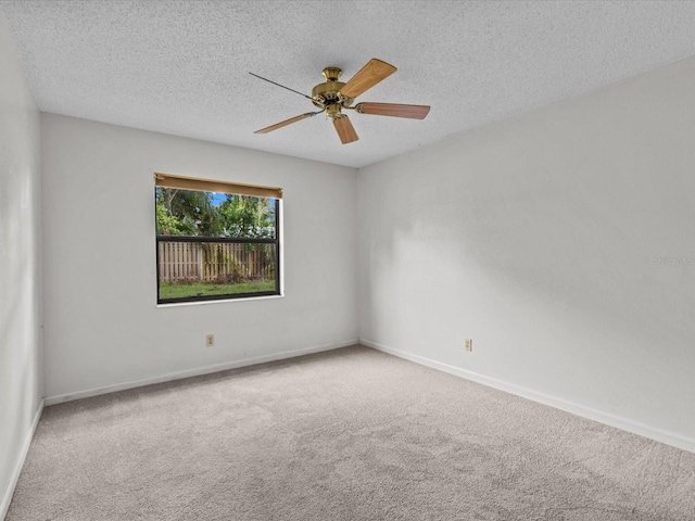 empty room with a textured ceiling, ceiling fan, and carpet floors