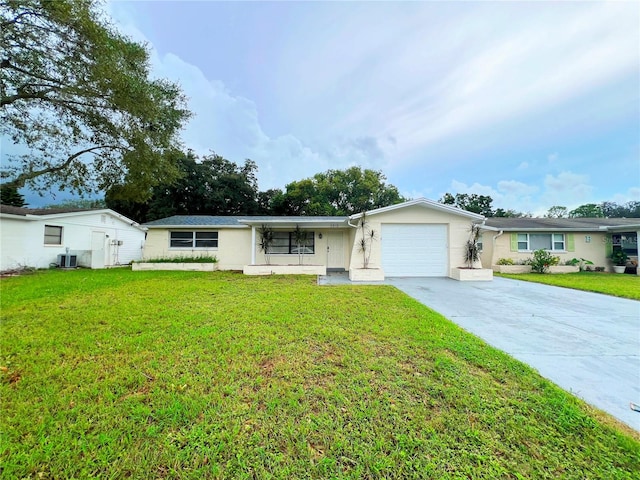 single story home featuring a garage, a front lawn, and central AC