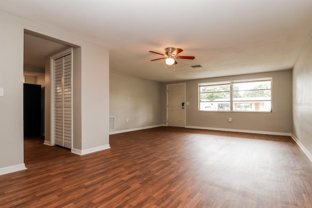 empty room featuring ceiling fan and dark hardwood / wood-style flooring