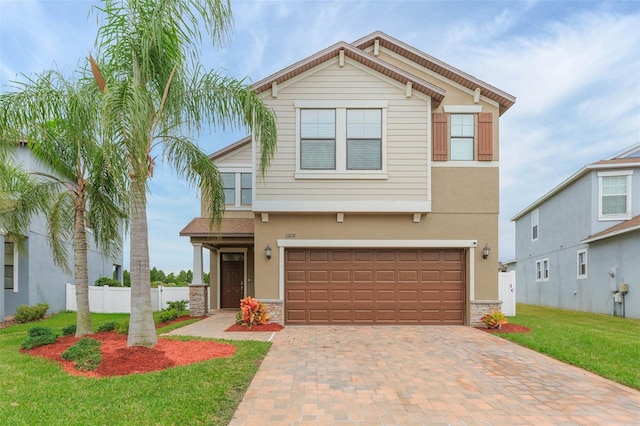 view of front of home with a garage and a front lawn