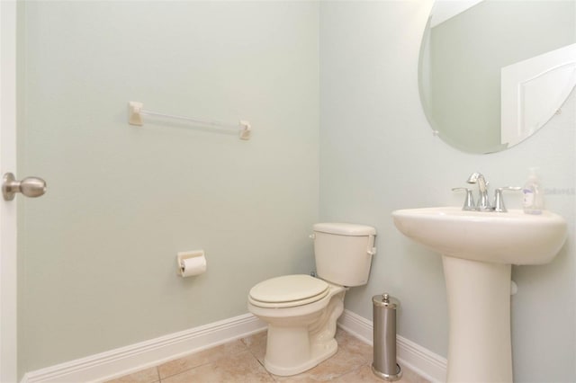 bathroom featuring sink, toilet, and tile patterned floors