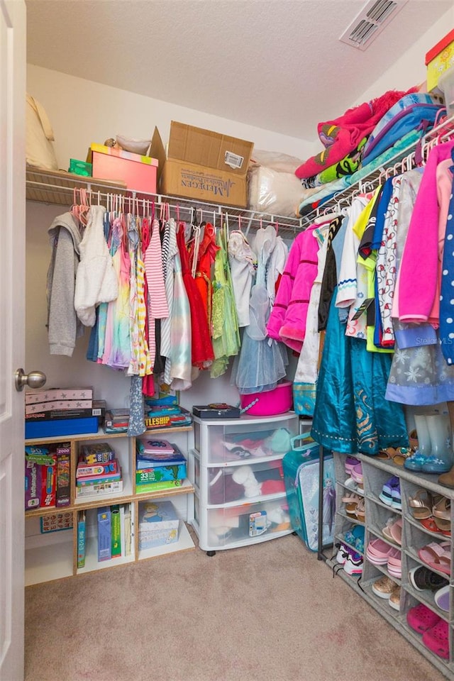 walk in closet with carpet flooring