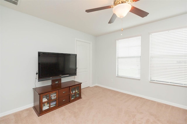 carpeted living room with ceiling fan