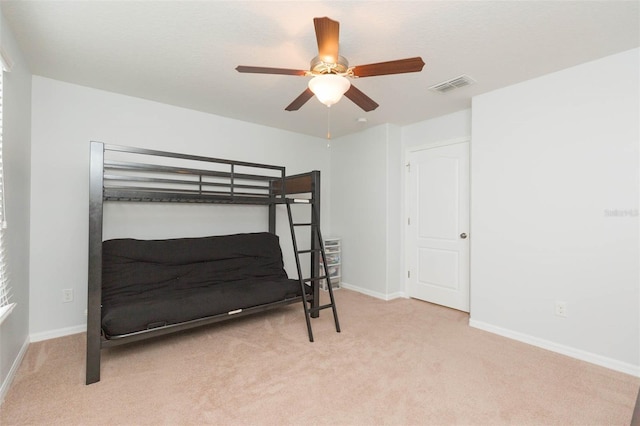 bedroom with ceiling fan and light colored carpet