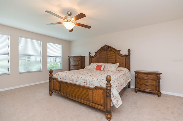 bedroom with light carpet and ceiling fan