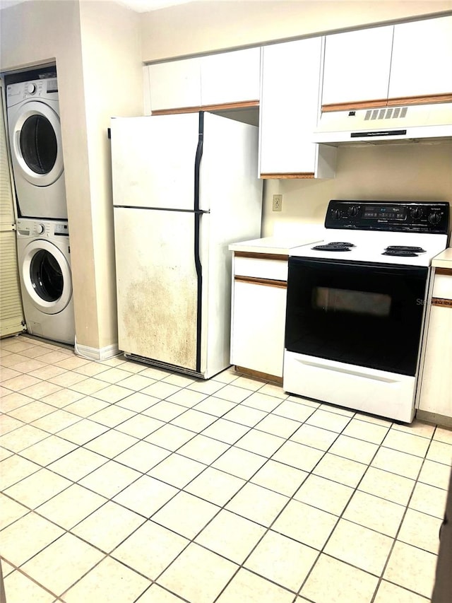 kitchen with white cabinetry, white appliances, stacked washer / dryer, and light tile patterned floors