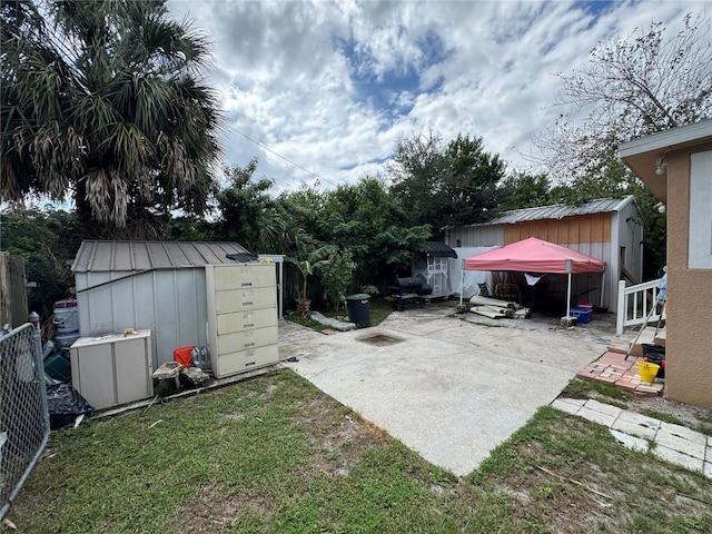 view of yard with a storage shed and a patio area