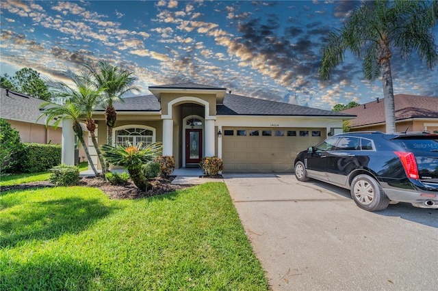 view of front of house with a garage and a lawn