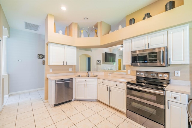 kitchen featuring appliances with stainless steel finishes, white cabinetry, sink, and light tile patterned floors