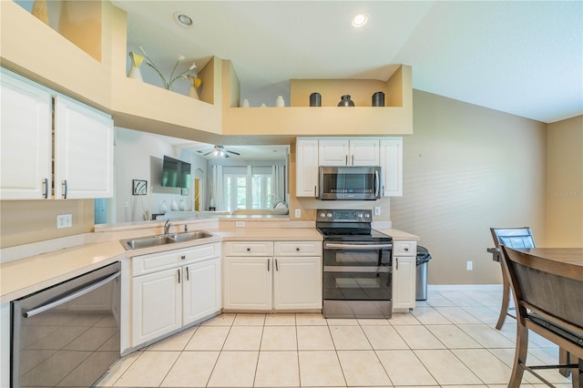 kitchen featuring light tile patterned flooring, appliances with stainless steel finishes, sink, and white cabinetry