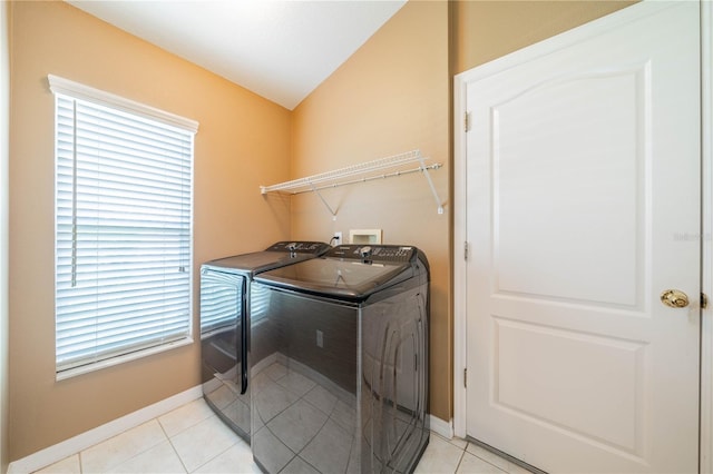 laundry area with light tile patterned flooring and washer and dryer