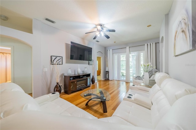 living room with ceiling fan, french doors, and hardwood / wood-style flooring