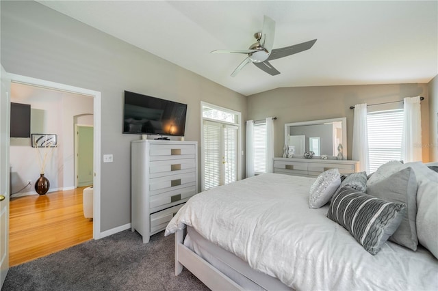 bedroom featuring carpet floors, lofted ceiling, and ceiling fan