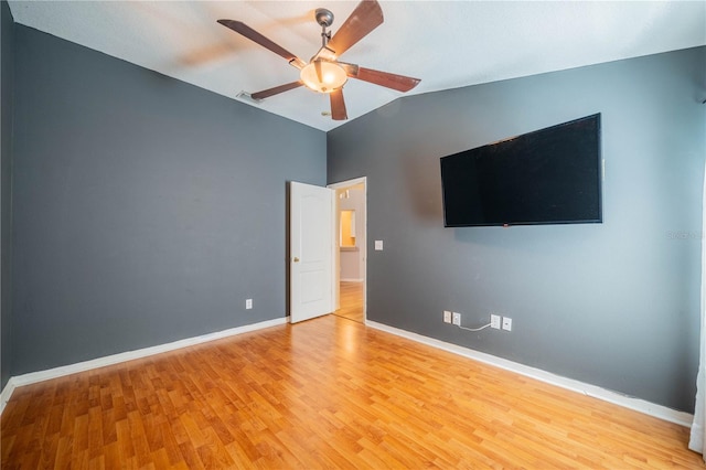 unfurnished bedroom with ceiling fan, light hardwood / wood-style flooring, and lofted ceiling