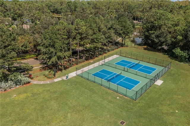 view of tennis court featuring a lawn