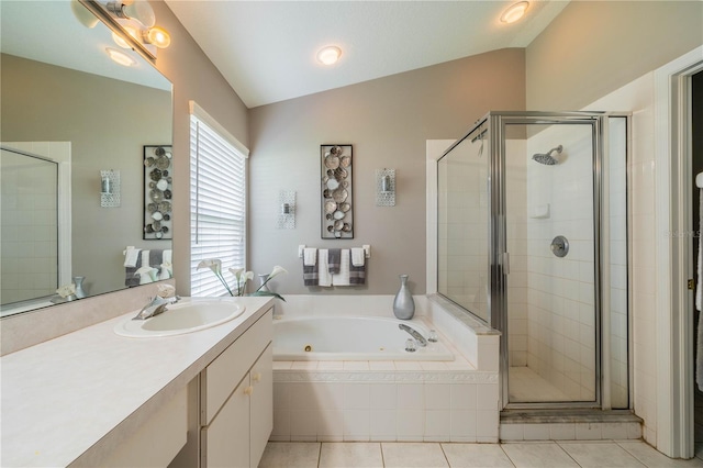 bathroom featuring independent shower and bath, vanity, lofted ceiling, and tile patterned floors