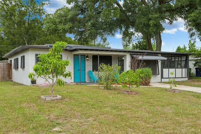 single story home featuring a sunroom and a front lawn